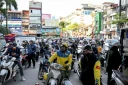 Des motocyclistes font la queue pour faire le plein d'essence dans une station-service à Hanoï, le 10 mars 2026 au Vietnam