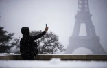 Des promeneurs sur l\'esplanade du Trocadéro recouverte de neige, face à la Tour Eiffel, le 6 février 2018 à Paris