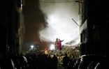 Les personnels de secours travaillent dans la nuit, sur les lieux de l'effondrement d'un immeuble dans le centre de Marseille (sud), le 9 avril 2023
