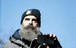 Jérôme Rodrigues, une des figures du mouvement des "gilets jaunes", filme la manifestation qui se déroule place d'Italie à Paris, le 12 février 2022