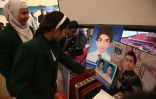 Des étudiants pakistanais regardent des photos de victimes de l'attentat contre une école de Peshawar lors d'une cérémonie en leur mémoire le 8 décembre 2015