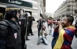 Un manifestant pro-Tibet fait face à des CRS français le 8 août 2008 sur les Champs-Elysees à Paris pendant la cérémonie d'ouverture des Jeux de Pékin