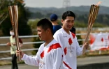 Des relayeurs pendant la première journée du relais de la torche olympique à Naraha (Japon) le 25 mars 2021