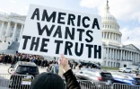 Un manifestant tient une pancarte "l'Amérique veut la vérité", demandant la publication des documents liés à l'affaire Epstein, devant le Capitole de Washington, siège du Congrès américain, le 12 novembre 2025