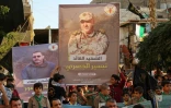 Les portraits des chefs militaires du Jihad islamique Tayssir Al-Jabari et Khaled Mansour (g), tués dans des frappes israéliennes, lors d'un rassemblement à Ramallah le 7 aout 2022