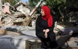 Une femme est assise au milieu des décombres de sa maison à Gaza, le 14 mai 2023, dans les territoires palestiniens