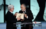 Le réalisateur américain George Lucas (G) reçoit la Palme d'or d'honneur des mains de Francis Ford Coppola lors de la cérémonie de clôture du 77e Festival de Cannes, le 25 mai 2024  
