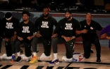 Les joueurs des Lakers, dont LeBron James, genou Ă terre, avant un match contre les Clippers, le 30 juillet 2020 Ă Lake Buena Vista en Floride