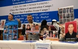 Des Ouïghours montrent des photos de leurs proches détenus en Chine pendant une conférence de presse à Istanbul, le 10 mai 2022