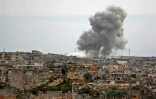 Une colonne de fumée s'élève au-dessus d'un quartier du village d'al-Bara, dans la province syrienne d'Idleb (nord-ouest), après un bombardement attribué à des avions russes, le 5 mars 2020