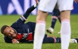 L'attaquant brésilien du Paris Saint-Germain, Neymar, se tord de douleur après un violent tacle de son compatriote de Lyon, le milieu de terrain Thiago Mendes, lors de leur match de L1, 1e 13 décembre 2020 au Parc des Princes