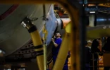 Un employé chinois travaille sur le fuselage d'un avion sur le sol de montage de l'usine d'Airbus de Tianjin le 1er mars 2016