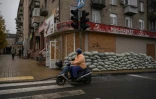 Dans une rue de Droujkivka, aux façades masquées par des panneaux de bois en cas de bombardements, dans l'est de l'Ukraine, le 10 octobre 2025
 