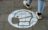 Un marquage au sol sur un trottoire appelle au port du masque à Berlin le 10 mars 2021