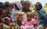 Au Niger, une mère présente un périmètre brachial (PB), un brassard tricolore, qui sert à mesurer l'épaisseur du bras et détecter la malnutrition, dans le village de Barago (sud), le 14 juillet 2016 