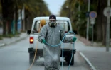 Un employé municipal désinfecte une rue pendant l'épidémie de coronavirus, le 1er avril 2020 à Tunis