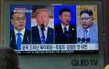 De gauche à droite, une télévision à Séoul montre le 11 mai 2018 les présidents sud-coréen Moon Jae-in, américain Donald Trump et chinois Xi Jinping, et le dirigeant nord-coréen Kim Jong Un