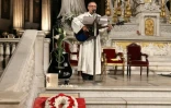 Un prêtre joue de la guitare pendant la messe hommage à Johnny Hallyday à l'égilse de la Madeleine à Paris, le 9 décembre 2018