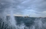 Un ferry passe sur le Bosphore alors que des vagues touchent la rive, le 23 décembre 2019 à Istanbul