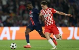 L'attaquant parisien Ousmane Dembélé (g) devant le défenseur de Gérone Ladislav Krejci, le 18 septembre 2024 au Parc des Princes 