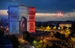 L'Arc de Triomphe aux couleurs de la France lors des scènes de liesse aux Champs-Elysées après le triomphe des Bleus au Mondial, le 15 juillet 2018