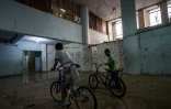 Des enfants font du vélo dans un immeuble squatté de la banlieue de Sao Paulo au Brésil, le 14 mai 2018