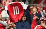 Un supporter brandit le maillot du milieu danois Christian Eriksen, évacué sur une civière après son malaise lors du match de groupes de l'Euro contre la Finlande, le 12 juin 2021 à Copenhague