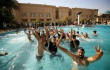 Des partisans de Moqtada Sadr se baignant dans un bassin dans la cour arrière du palais de la République à Bagdad, le 29 août 2022