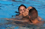L'entraîneure de l'équipe américaine de nage artistique et synchronisée Andrea Fuentes (g) tient la tête de sa nageuse Anita Alvarez qui a perdu connaissance lors des Mondiaux de natation, à Budapest, le 22 juin 2022