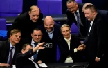 Des membres du parti d'extrême droite allemand AfD, dont la co-dirigeante Alice Weidel, prennent une photo de groupe pour fêter le vote d'une motion visant à durcir la politique migratoire, le 29 janvier 2025 au parlement à Berlin