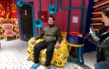Un visiteur assis sur un "fauteuil à pets" au musée du rire HaHaHouse à Zagreb, le 21 janvier 2025 en Croatie