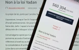 Cette photo prise le 8 avril 2026 à Mulhouse, dans l'est de la France, montre un smartphone et un écran d'ordinateur affichant une page du site web de l'Assemblée nationale française indiquant qu'une pétition intitulée "Non à la loi Yadan" a recueilli plus d'un demi-million de signatures.