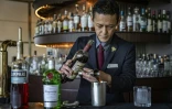 Le barman Shingo Miyachi prépre un cocktail negroni au bar de l'hôtel Hilton de Narita, au Japon, le 19 juin 2026