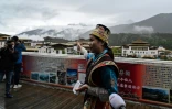 Une guide montre le village touristique de Lunang, à Nyingtri, dans la région autonome chinoise du Tibet, durant une visite de presse le 2 juin 2021
