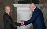 Le ministre italien de la Défense Guido Crosetto (D) et son homologue britannique John Healey se serrent la main durant la cérémonie d'accueil d'un G7 Défense à Naples le 19 octobre 2024