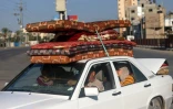 Des Palestiniens fuient le camp de réfugiés de Bureij dans le centre de la bande de Gaza, le 4 novembre 2023