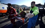 Sauveteurs transportant un passager du Costa Concordia sur un brancard, le 14 janvier 2012, au lendemain du naufrage du bateau, à Porto Santo Stefano, en Italie