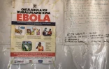 Une affiche d'information indique les numéros d'urgence liés à Ebola,dans une tente au poste-frontière de Busunga, entre l'Ouganda et la République démocratique du Congo, à Bundibugyo, le 18 mai 2026. 
