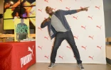 Usain Bolt lors de la présentation de son autobiographie dans un magasin Puma à Santa Monica aux Etats-Unis le 19 novembre 2013