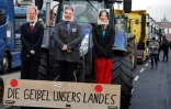 Des portraits du chancelier allemand Olaf Scholz, des ministres de l'Economie Robert Habeck et des Affaires étrangères, Annalena Baerbock, sur un tracteur lors d'une manifestation des agriculteurs à Berlin, le 15 janvier 2024