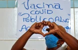 Un sans-abri fait un coeur avec ses mains pour remercier d'avoir été vacciné contre le Covid-19 dans le cadre d'une campagne de vaccination destinée aux sans-domicile-fixe dans les rues de Sao Paulo, au Brésil, le 30 mars 2021