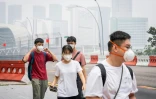 Des passants équipés de masques dans une rue de Singapour le 16 octobre 2026