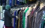 Une femme dans une boutique de vêtements nationaux au bazar Korvon à Douchanbé, le 2 décembre 2024 au Tadjikistan