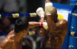 Le boxeur Tun Tun Min combat contre son adversaire américain Cyrus "Black Dynamite" Washington, le 20 décembre 2015 à Rangoun 