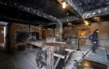 Un visiteur passe devant des fours crématoires au musée de l'ancien camp nazi d'Auschwitz-Birkenau, le 14 janvier 2025 dans la ville polonaise d'Oswiecim