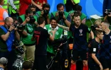 Mario Mandzukic (g), buteur pour la Croatie face aux Anglais au Mondial, réconforte le photographe de l'AFP retrouvé enseveli sous les joueurs croates, le 11 juillet 2018 à Moscou
