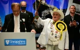 Howling Laud Hope (2e dr) du Monster Raving Loony Party pavoise alors que les résultats de l'élection partielle dans le North Shropshire en Angleterre sont annoncés à Shrewsbury le 17 décembre 2021