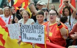 Des habitants tiennent des pancartes souhaitant la bienvenue au couple royal espagnol à Ceutra le 13 octobre 2026