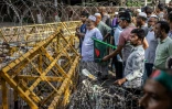 Des manifestants arborant le drapeau du Bangladesh bloquent un rassemblement des partisans de l'ancienne Première ministre Sheikh Hasina le 15 août à Dacca