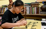 Hoang Thi Thanh Huyen apprend la calligraphie chez le calligraphe Nguyen Thanh Tung, le 15 mai 2025 à Hanoï, au Vietnam